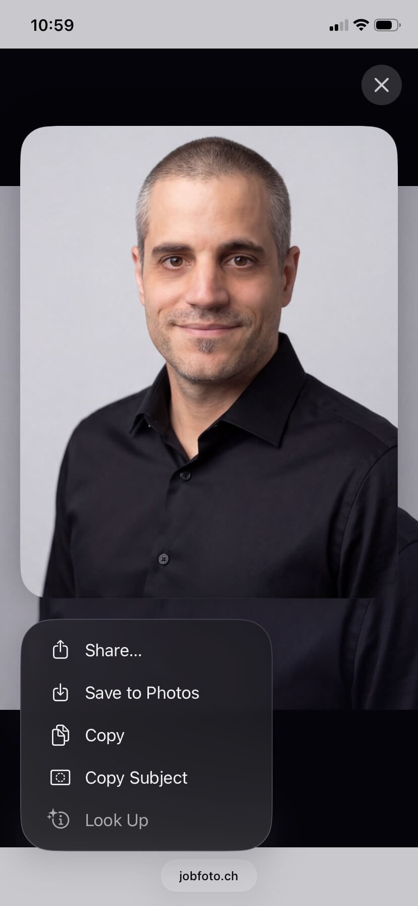 Long-press menu showing Save to Photos in Safari on iPhone